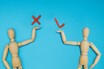 Wooden mannequin with empty miniature shopping cart running for sales on red background. Mockup for shopping, sales, black friday, copy space, side view.