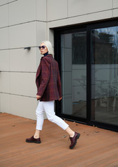 Ground girl model in a stylish beige bow. Street style fashion.