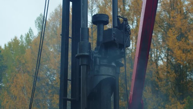 Old pile hammer drive concrete pile ram. Machine building house foundation.