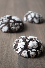 Traditional holiday cocoa crinkled cookies on a rustic wooden surface