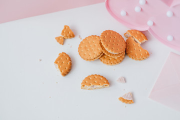 Sweet creamy filling crackers on a white-pink pastel background. 