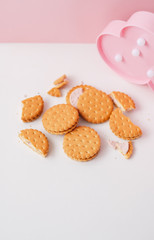 Sweet creamy filling crackers on a white-pink pastel background. 