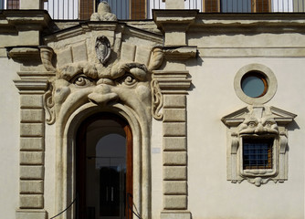Fototapeta na wymiar Streets of Rome. Door and window in Mannerist Reinaissance façade in Rome. Italy 