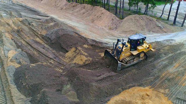 Bulldozer leveled ground, sand. Road construction, infrastructure transport.
