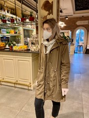 beautiful girl in a flu mask, goggles and gloves chooses food in a supermarket, food and food on a blurred background.  shopping during coronavirus -covid-19