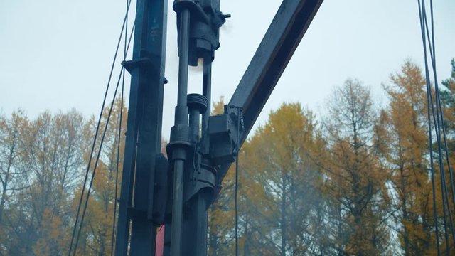 The old pile driver with hammer clog ram work. Building the house foundation.