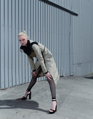 The style of street fashion. Professional model of a blonde in stylish clothes in an urban environment.