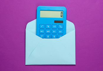 Calculator with an envelope on a purple background. Top view