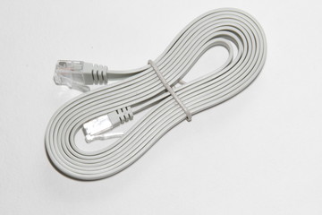 Patch cord with connectors RJ45. Gray computer network ethernet cable isolated on white background, closeup