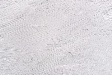 White background with a textured surface. Plastered wall or table.