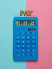 Calculator with the word pay on pink blue pastel background. Top view