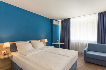 Fototapeta na wymiar Apartment interior, bedroom with blue wall