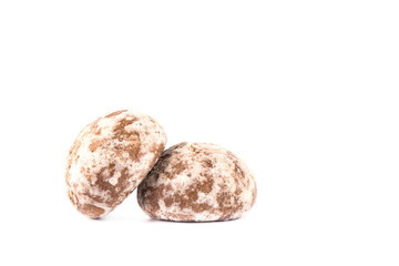 Two glazed gingerbreads with fruit filling isolated on a white background.