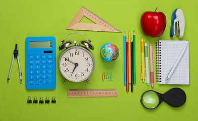 Back to school. School and office supplies on green background. Educational, study concept. Top view.