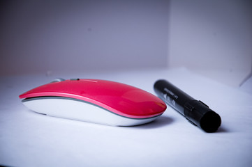 wireless pink mouse with black marker on gray background