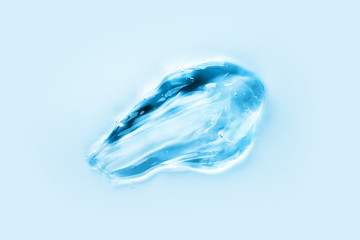 Transparent gel with bubbles closeup on light blue background, top view