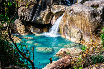 A crystal clear blue coloured natural swimming pool enroute Rainbow falls ahead Nongriat village in...