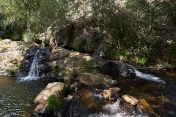 Naklejka na ściany i meble Beautiful waterfall in Penedo Furado Passadico walkway in Vila de Rei, Portugal