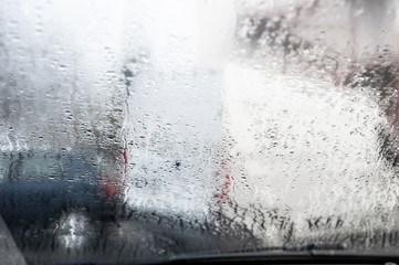Steamy car windshield on a autumn rainy/foggy day. Concept of safety driving problem