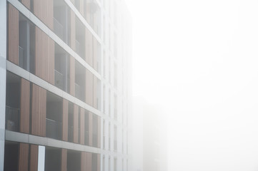 Obraz premium Modern apartment buildings in a foggy morning