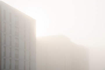 Modern apartment buildings in a foggy morning