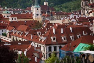 Naklejka premium view of the city, top view, visible red roofs of tiles. Sunny weather, blue sky in perspective