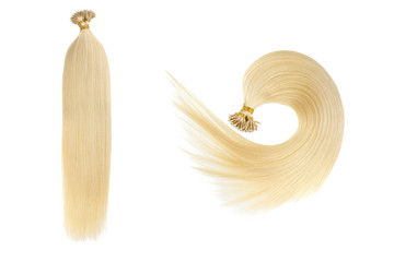 Set of two fake women hair extensions in tails, isolated on white background. Light blonde or gold color.