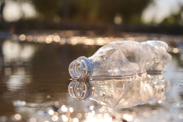 Waste from plastic bottle floating on the water in swamps is a problem and water pollution with...