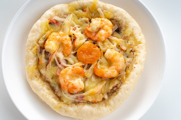 Pizza Cheese with Shrimp, Pork, Imitation Crab Stick and Salted Eggs on White Dish Wood Table.