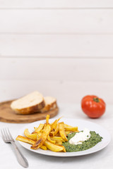 French fries with spinach tomato and sliced bread. Copy space with food concept