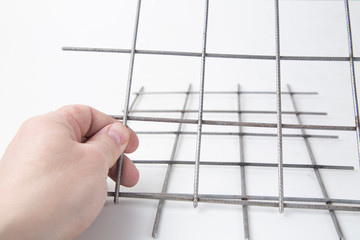 Iron mesh for laying bricks on a white background.