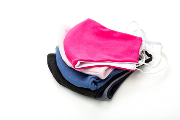 a stack of protective face masks against coronavirus made of dense fabric, isolated on a white...