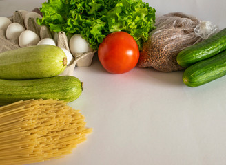 Food for donations. Healthy food on white background. spaghetti, buckwheat,eggs, cucumber, tomato, zucchini, lettuce. Food for quarantine isolation period. Food delivery, donation, coronavirus.