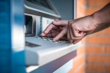 Entering a debit card pin on an ATM keyboard