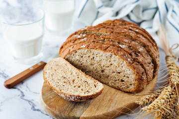 Wholegrain rye bread with glasses of milk