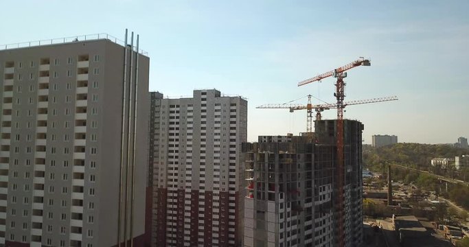Drone Aerial view of high rise residential complex under construction. Building cranes building new apartment building construction.