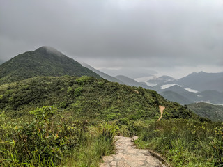 trail on a foggy day around hills in Hong Kong