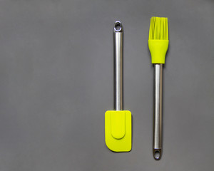 Light green metal cooking utensils on the grey background