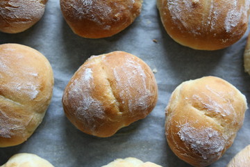 Fresh bread for breakfast sandwich - wheat rolls on a baking tray removed from the oven