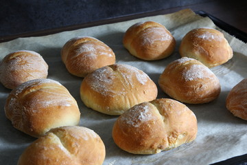 Fresh bread for breakfast - hot crisp rolls best for sandwich on a baking tray removed from the oven