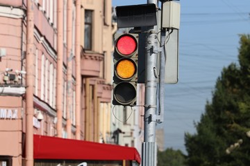 Traffic sign  on the metal  post. Red and Yellow  traffic light.