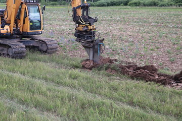 EXCAVATOR Works on digging the Trench for a cable 