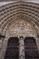 Fototapeta na wymiar Entrance and facade of Notre Dame cathedral Paris, France