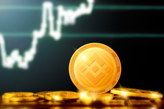 BINANCE Coin cryptocurrency; BINANCE golden coin on the background of the chart