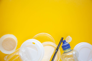 Human household waste on a yellow background. Say no to the plastic. The concept of recycling and ecology. Copy space for text.
