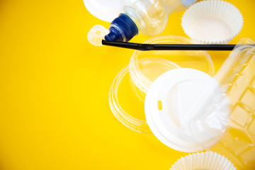Human household waste on a yellow background. Say no to the plastic. The concept of recycling and ecology. Copy space for text.
