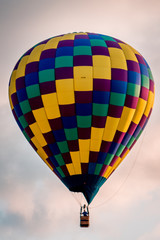 Hot air balloon floating by during a beautiful sunset in the summer during an airshow in Michigan