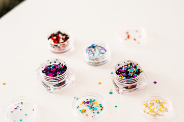 Nail designs on tips and manicure set on a colored background.