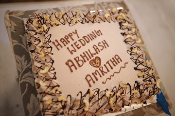 Indian reception wedding cake with roses and donuts