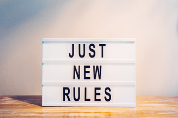 The words JUST NEW RULES on the lightbox. New beginnings, new life or new business concept